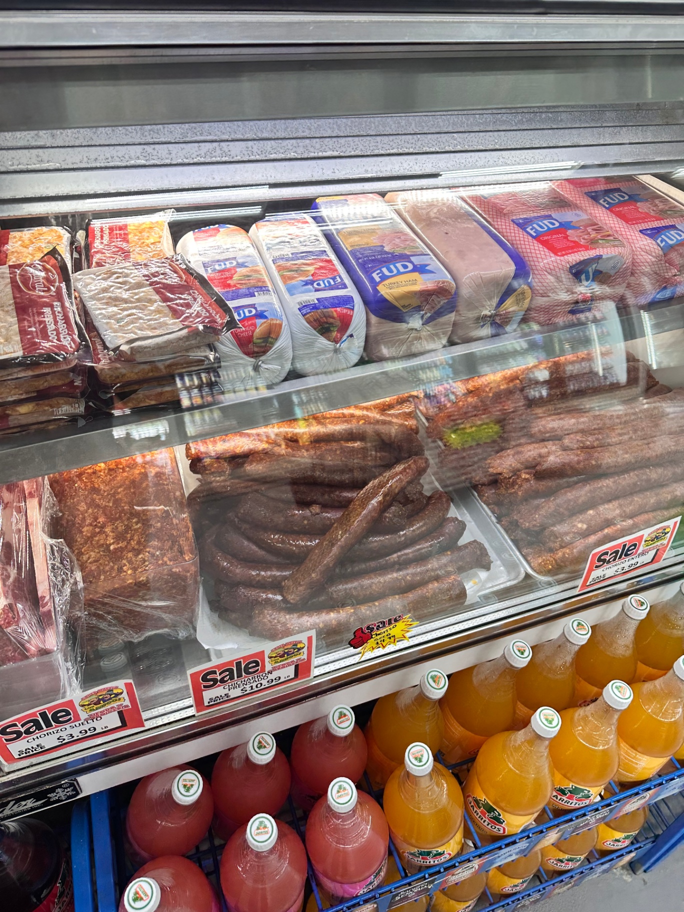 Chorizo, chicharrón prensado, and FUD deli meats in the carnicería case