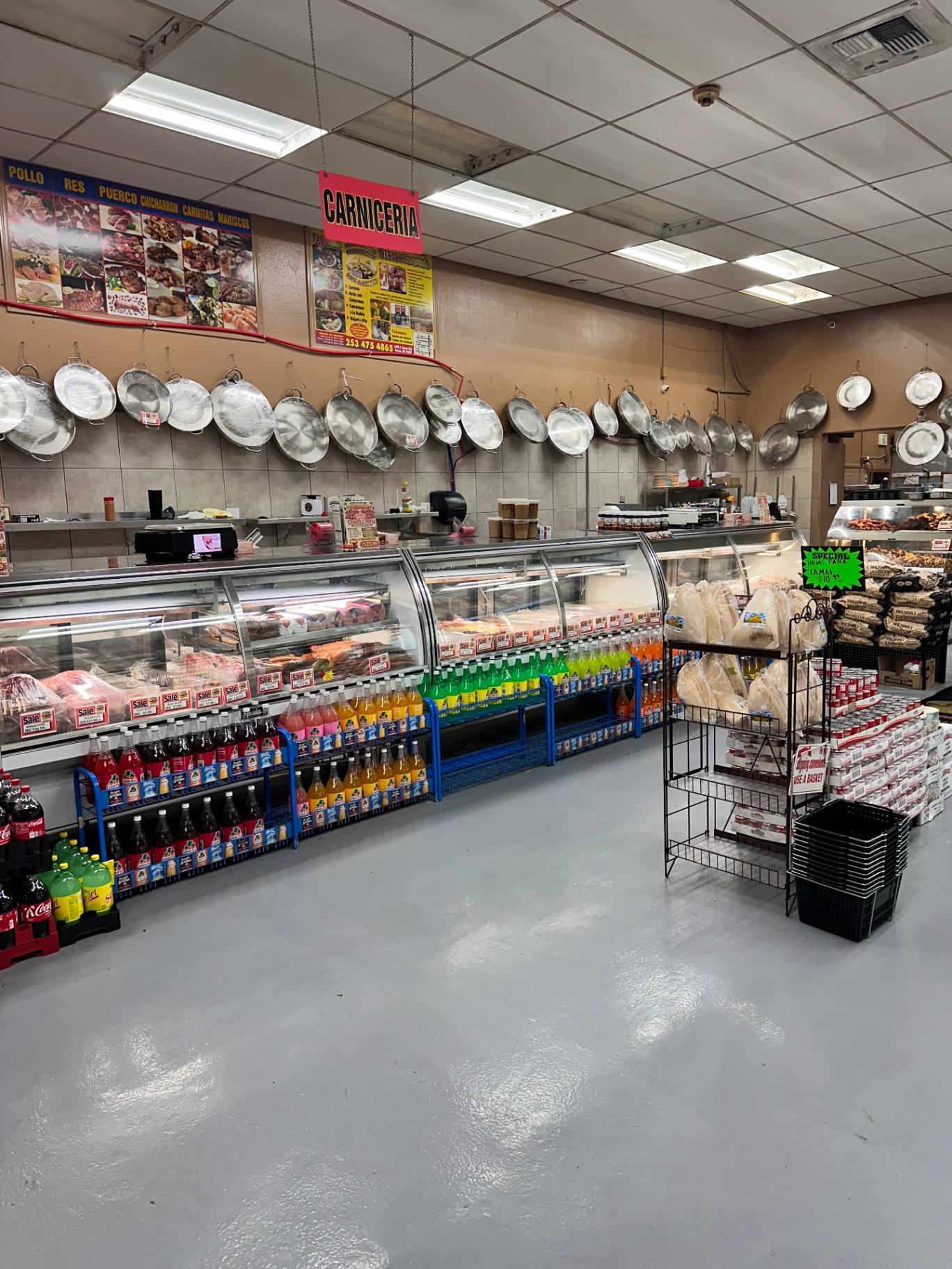 Wide view of the Los Amigos carnicería counter under the CARNICERIA sign