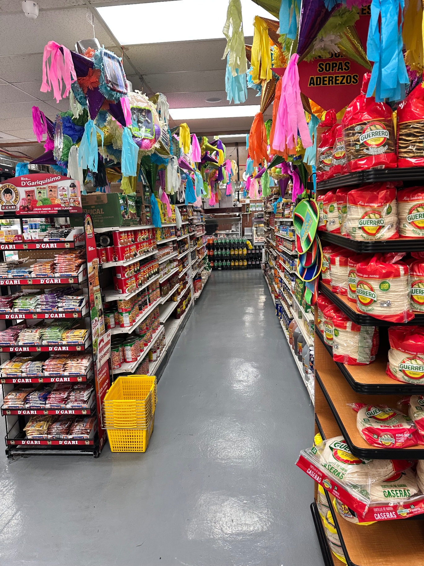 Grocery aisle with hanging piñatas, D'Gari gelatins, and Guerrero tortillas